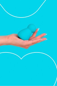 Fairygasm Applust vibrator in blue held in hand, showing size and texture