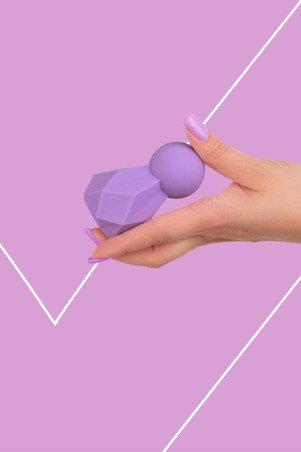 Fairygasm BlissKey vibrator in purple held in hand, highlighting ergonomic design